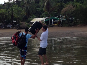 Tiron with luggage at beach on Osa